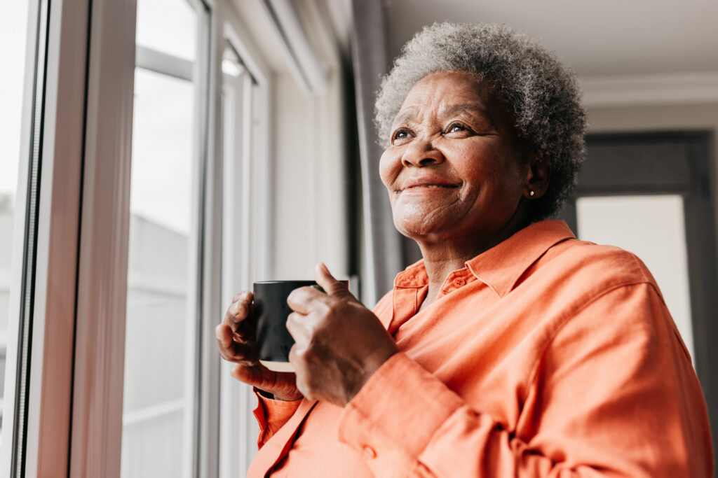 Warm-hearted senior woman enjoying morning coffee at Vista Prairie at Windmill Ponds senior living community in Alexandria, Minnesota.