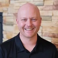 A smiling senior man enjoying life at Vista Prairie at Windmill Ponds in Alexandria, MN, senior living community with modern amenities and supportive care options.