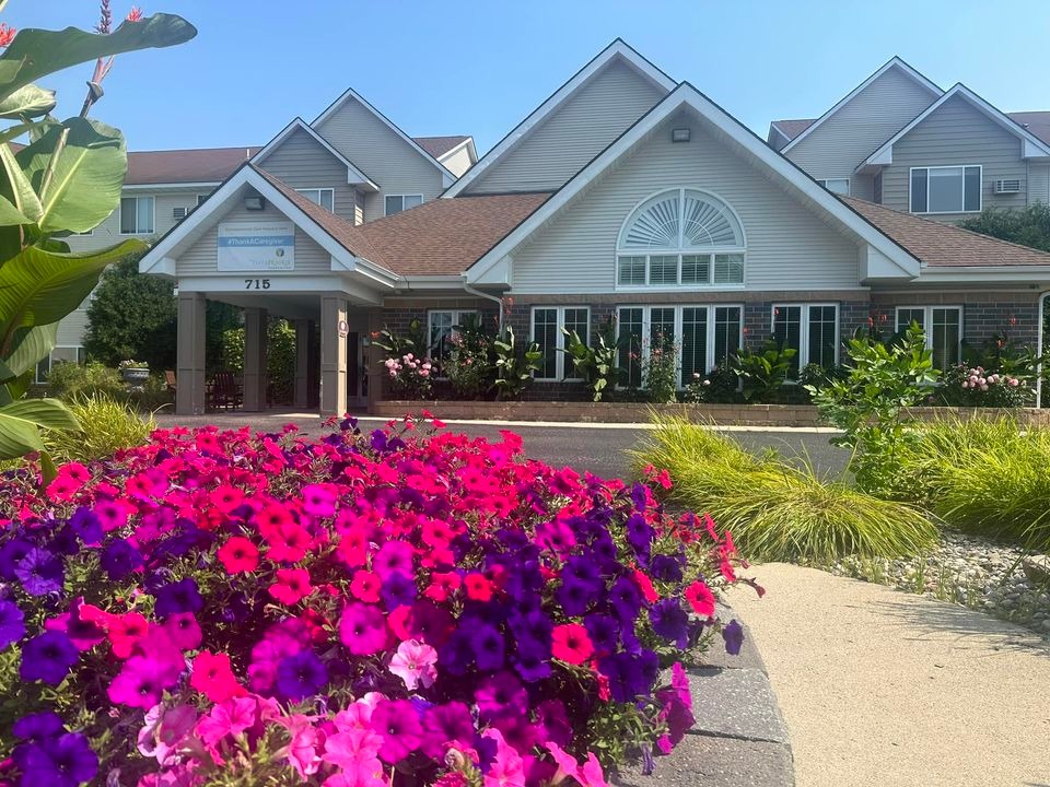 picture of the entrance to Vista Prairie at Windmill Ponds in Alexandria, Minnesota, with blooming petunias out front