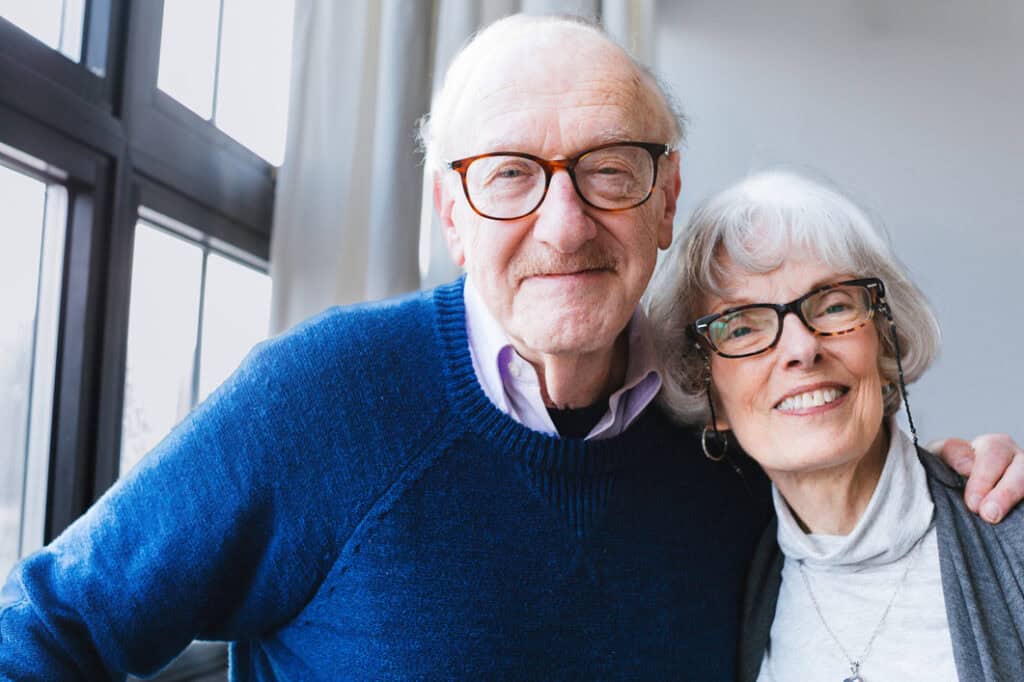 Elderly couple smiling and enjoying quality time together at Vista Prairie senior living facility in New Ulm, Minnesota.