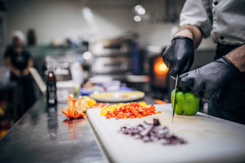 Freshly chopped vegetables being prepared in a professional kitchen for senior living dining at Vista Prairie at North Pointe in North Mankato, Minnesota.