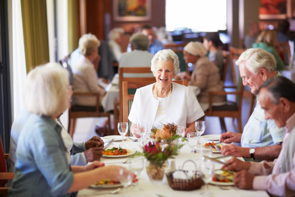 Beautiful senior residents enjoying a meal together at Vista Prairie senior living community in Redwood Falls, with a focus on social engagement and comfortable living for older adults.