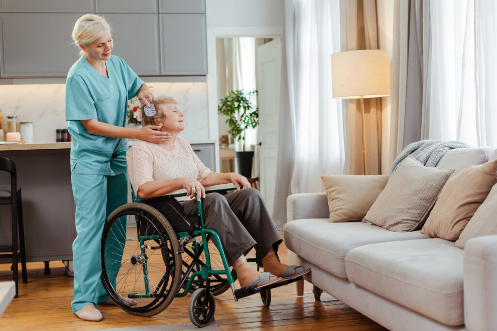 Comfortable senior care at Vista Prairie at Garnette Gardens, featuring professional staff providing grooming and personal assistance in a warm, inviting senior living environment in Redwood Falls, MN.