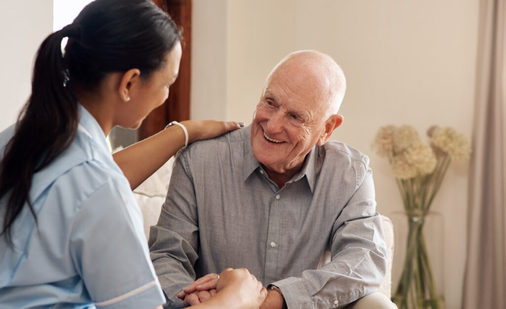 Caring senior living staff supporting elderly man at Vista Prairie at Eagle Pointe in St. Francis, Minnesota.