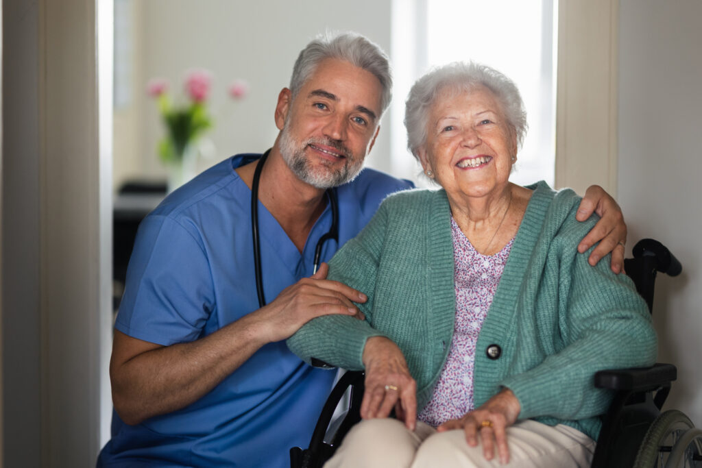 A caring healthcare professional with a senior woman in a wheelchair, showcasing compassionate elderly care at Vista Prairie senior living community.