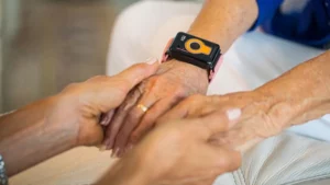 Handheld health monitoring device on senior's wrist at Vista Prairie Copperleaf senior living in Willmar, Minnesota.